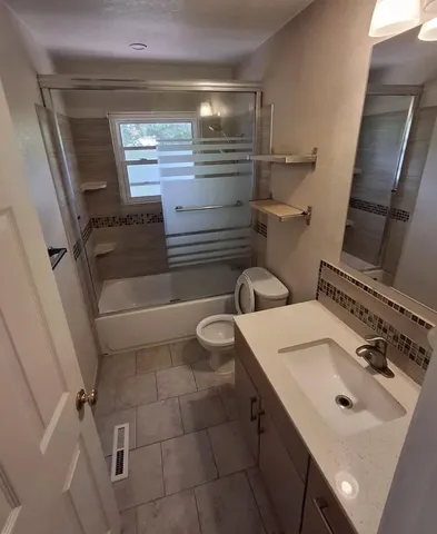 a bathroom with a sink toilet and tub