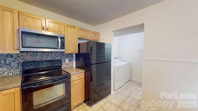 a kitchen with a stove microwave and refrigerator