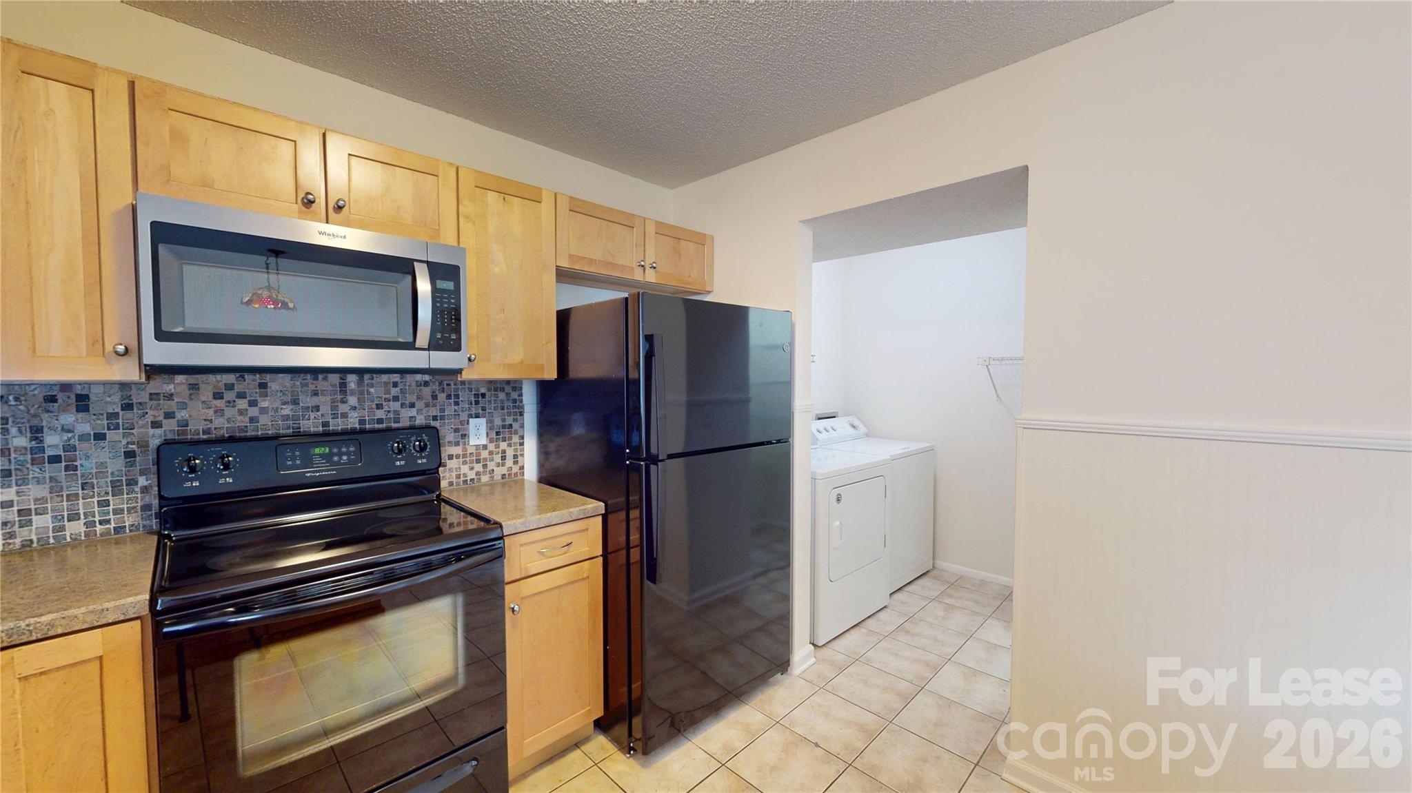 1211 Scaleybark Road Charlotte, NC 28209 - Photo 11 of 29 a kitchen with a stove microwave and refrigerator