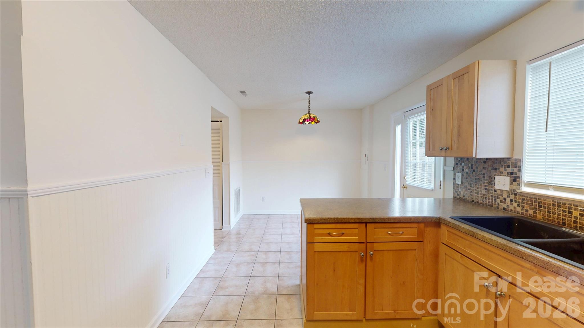 1211 Scaleybark Road Charlotte, NC 28209 - Photo 12 of 29 a kitchen with granite countertop a sink and a refrigerator