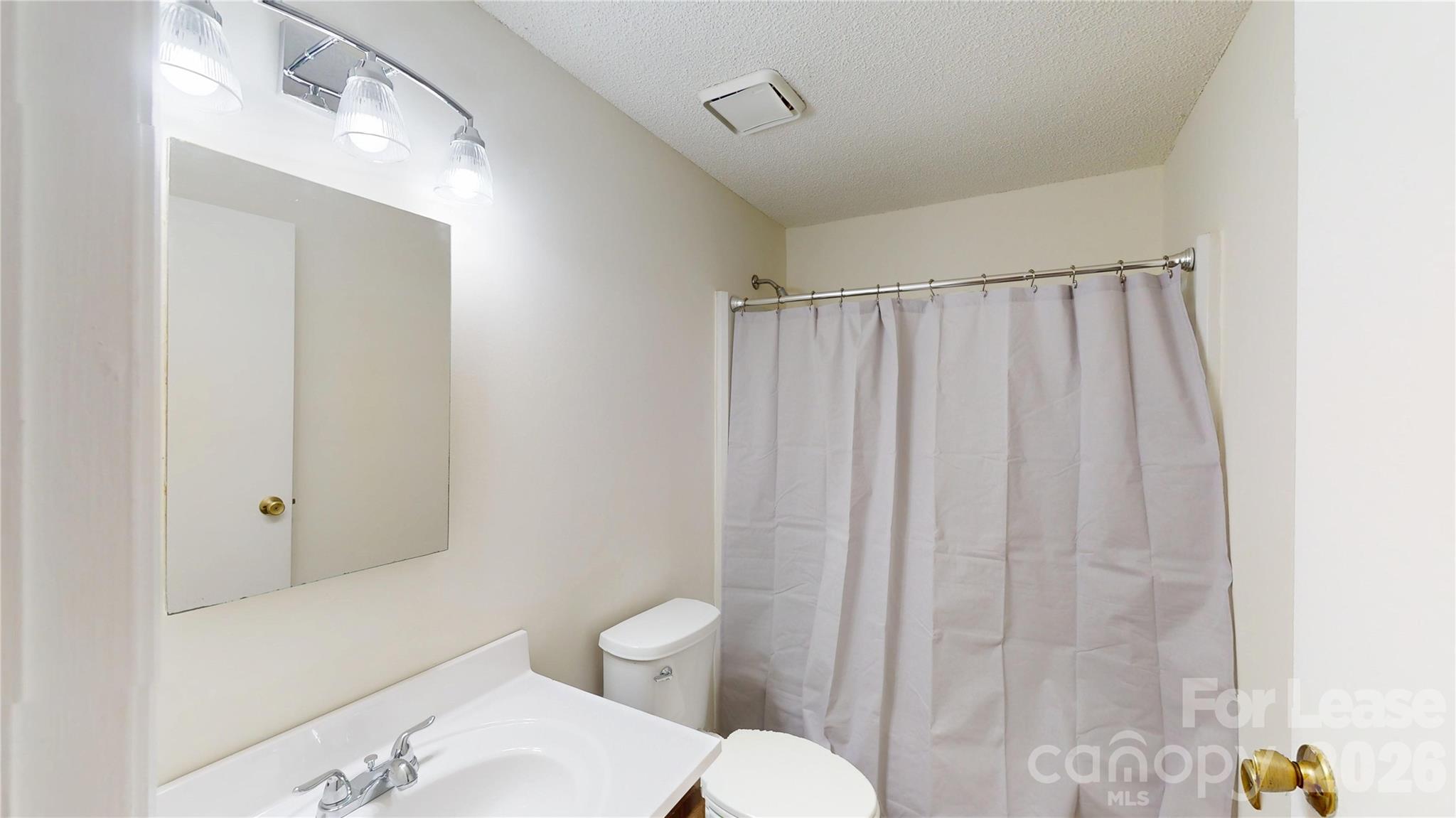 1211 Scaleybark Road Charlotte, NC 28209 - Photo 24 of 29 a white toilet sitting next to a bathroom sink