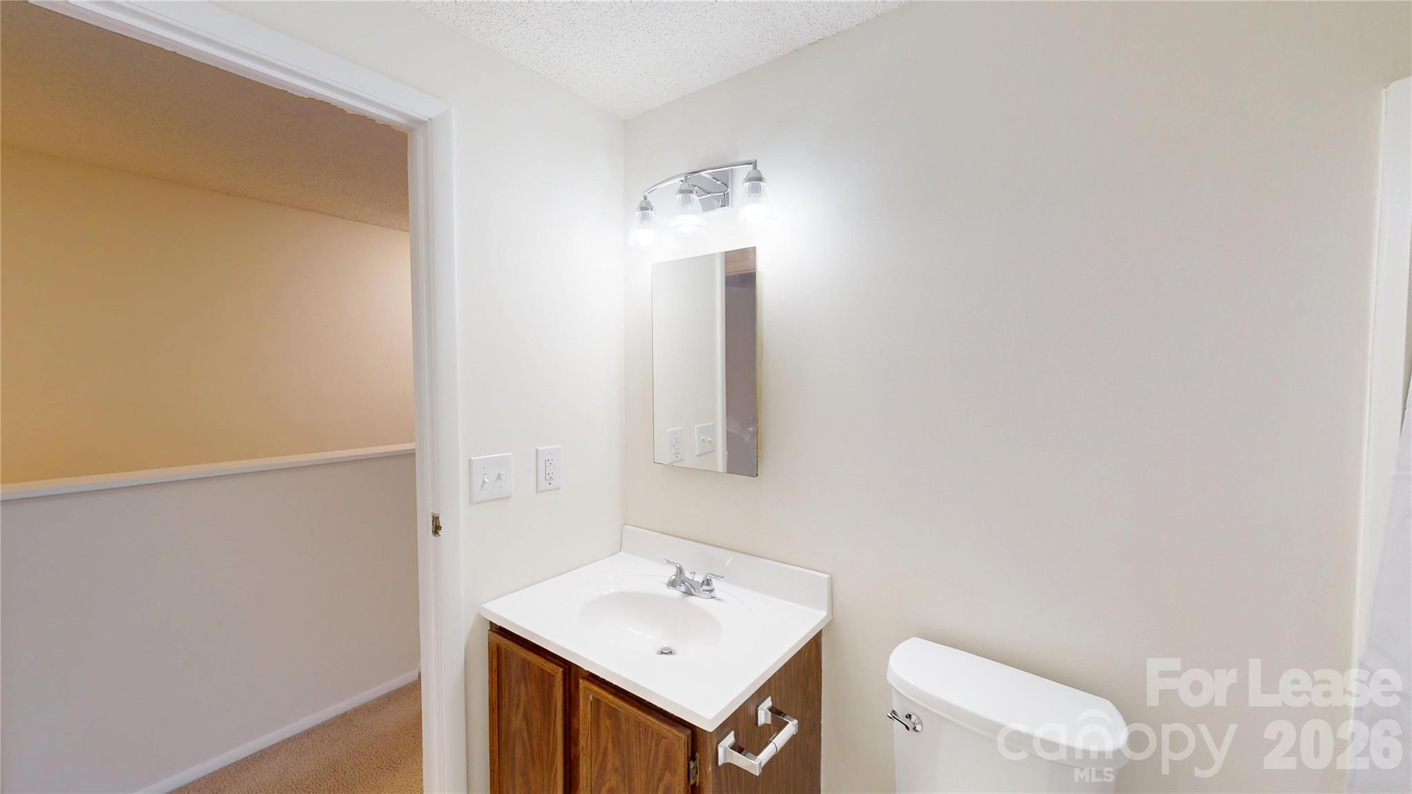 1211 Scaleybark Road Charlotte, NC 28209 - Photo 25 of 29 a bathroom with a sink vanity and a toilet