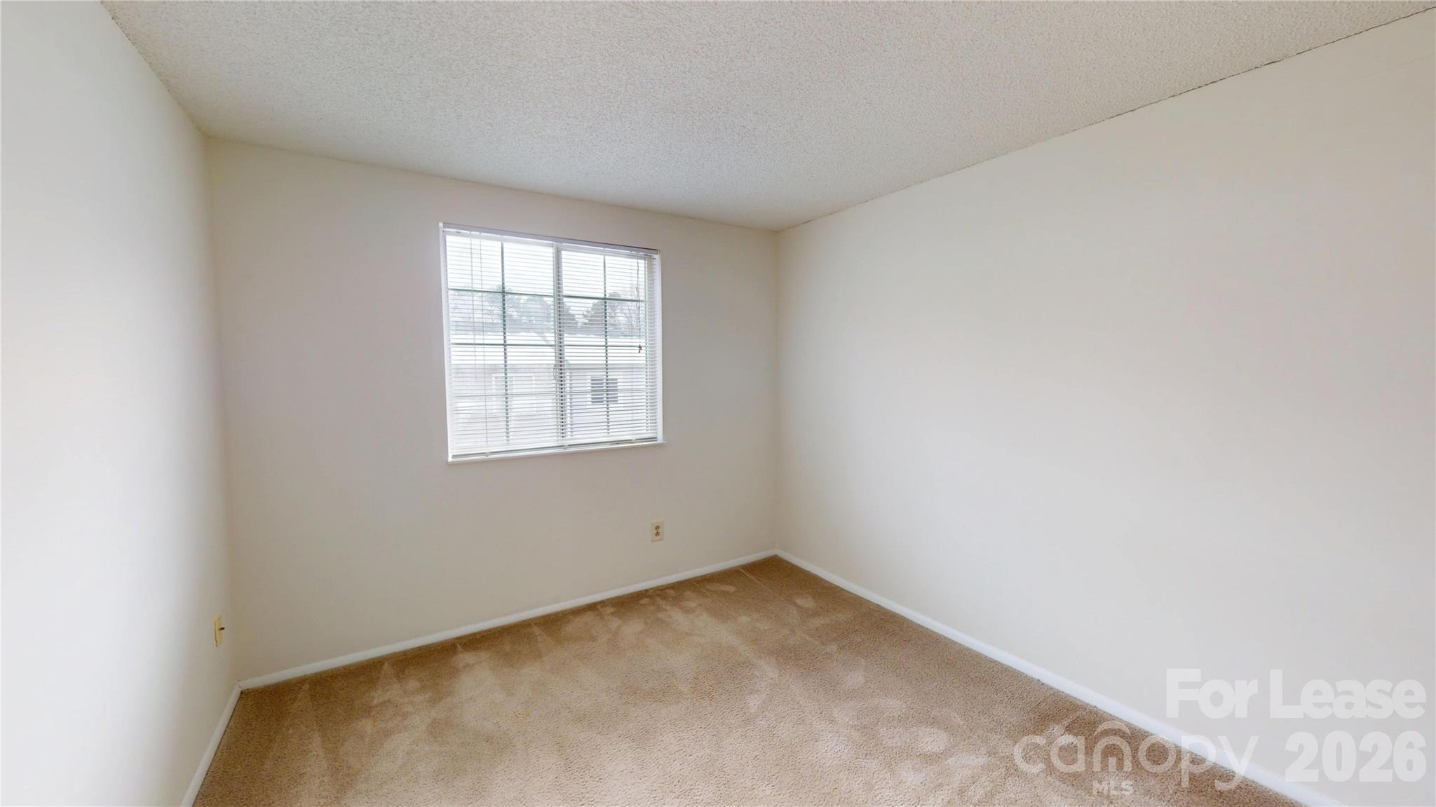 1211 Scaleybark Road Charlotte, NC 28209 - Photo 28 of 29 an empty room with a window