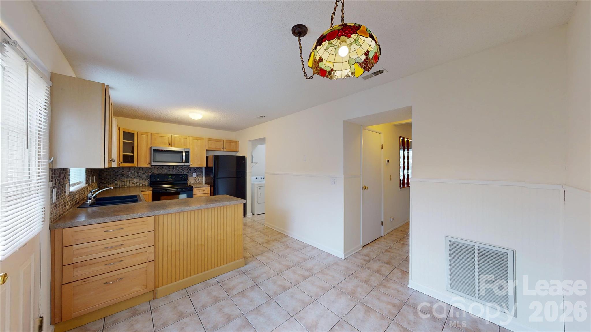 1211 Scaleybark Road Charlotte, NC 28209 - Photo 8 of 29 a kitchen with a cabinets and chandelier