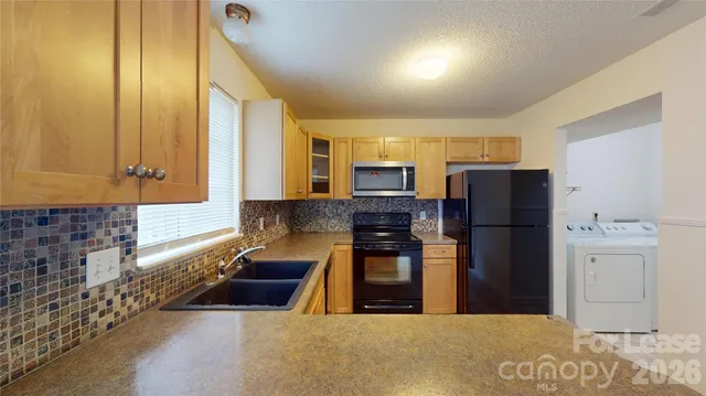 a kitchen with stainless steel appliances a refrigerator and a stove