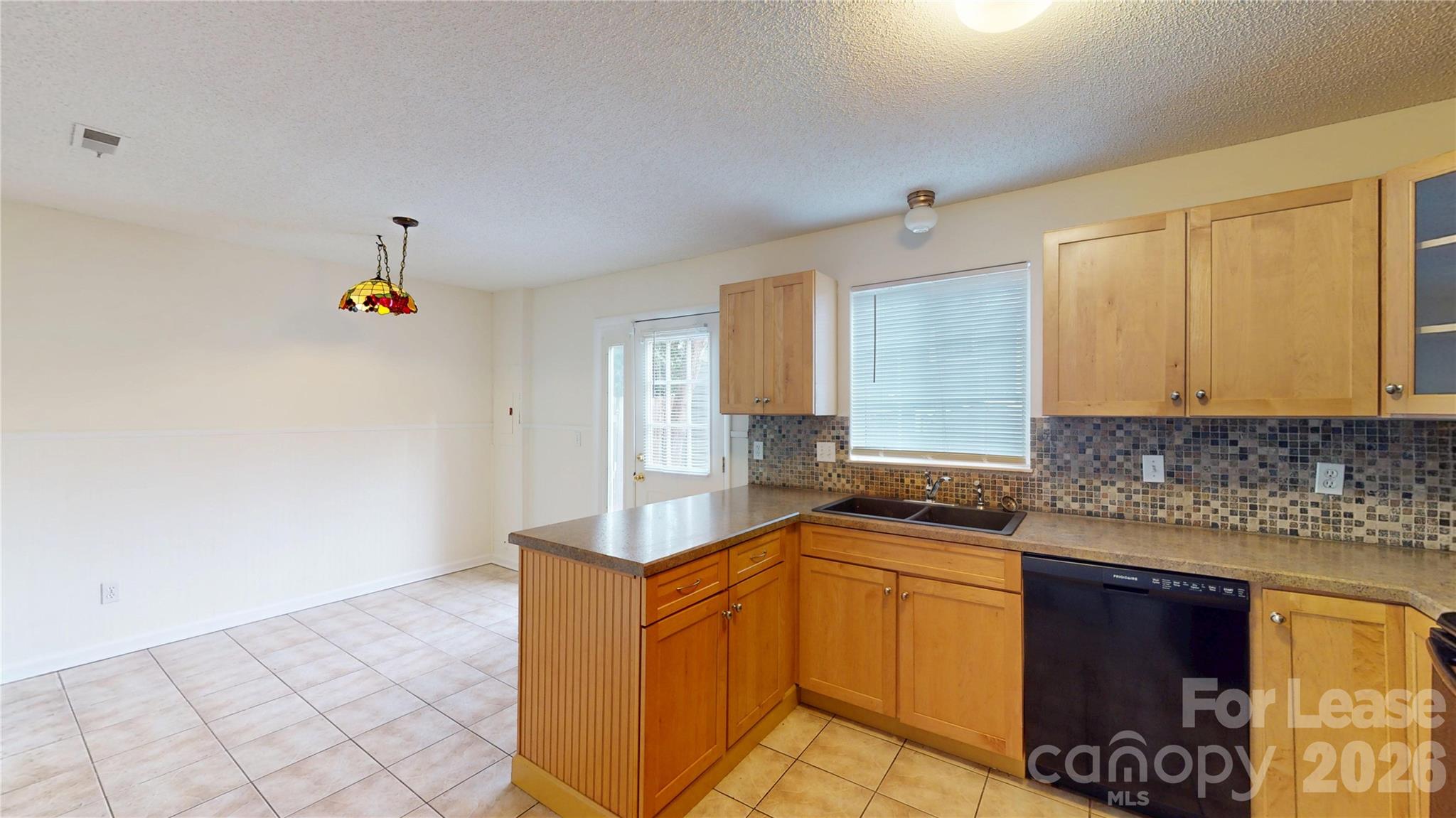 1211 Scaleybark Road Charlotte, NC 28209 - Photo 10 of 29 a kitchen with granite countertop a sink and cabinets