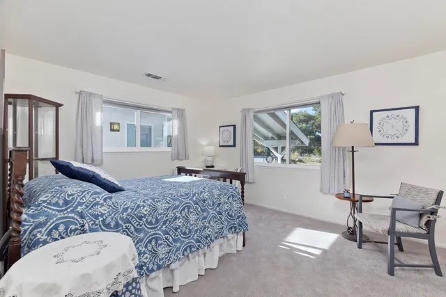 a bedroom with a large bed and a dresser