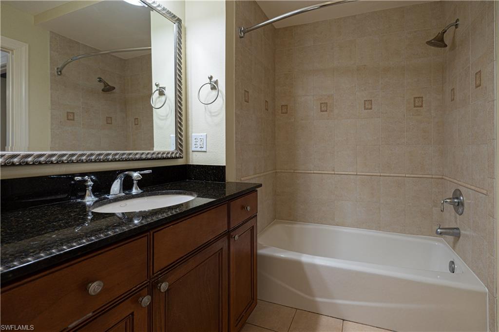 1362 Centre Ct Ridge Drive, Unit 101 Reunion, FL 34747 - Photo 9 of 25 Bathroom featuring tiled shower / bath, tile flooring, and vanity