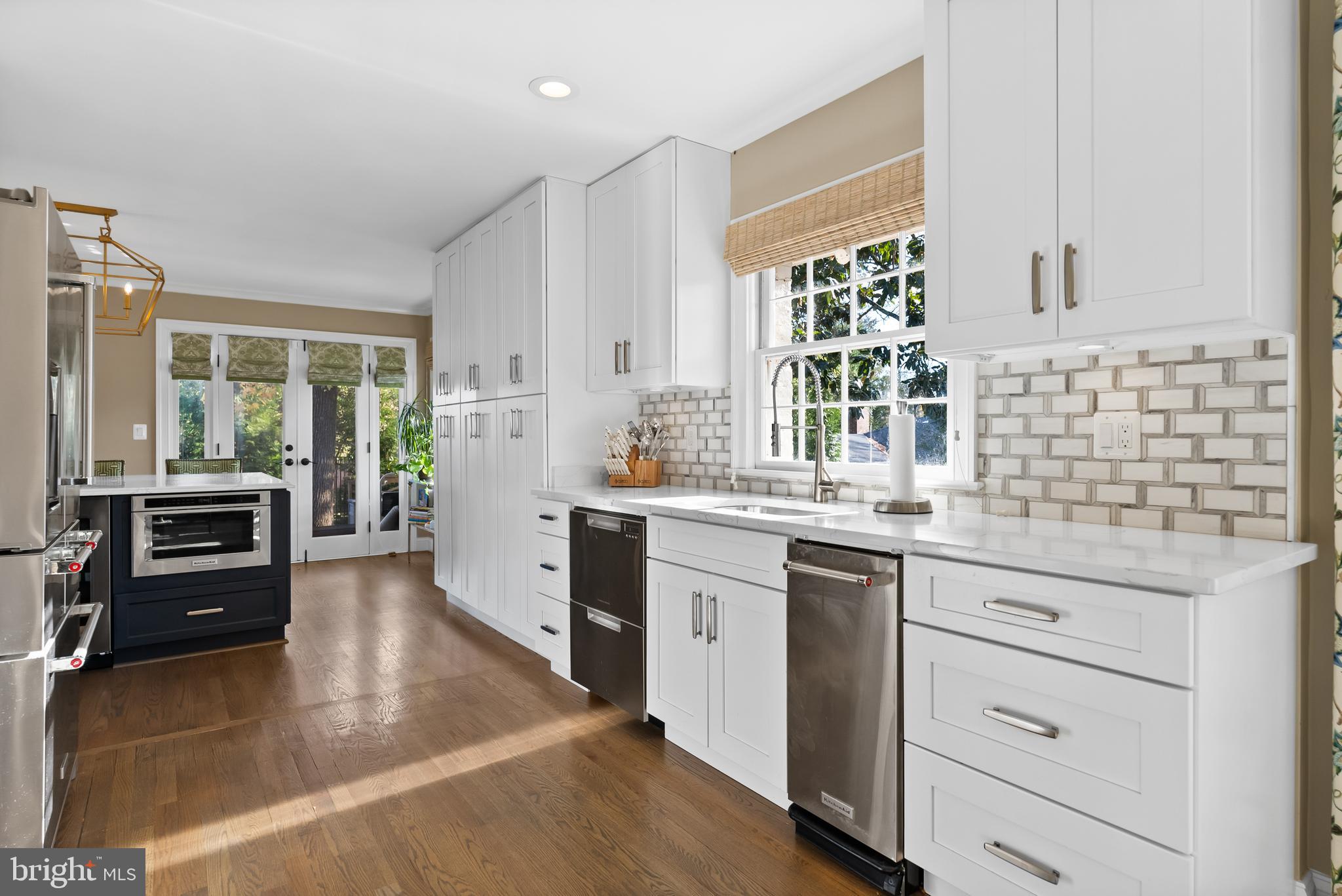 1101 Gatewood Drive Alexandria, VA 22307 - Photo 23 of 63 a kitchen with stainless steel appliances kitchen island granite countertop a stove a sink and white cabinets