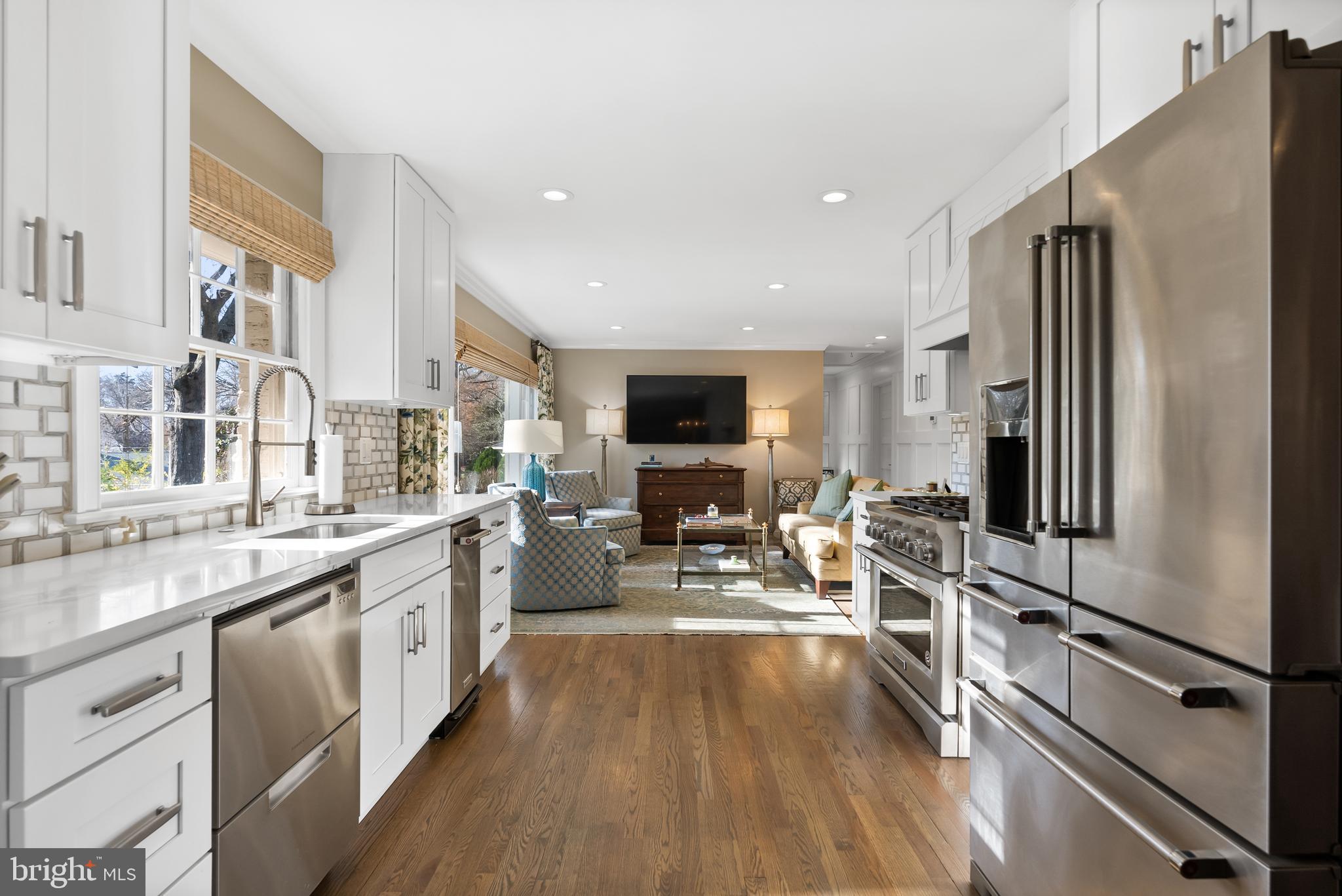 1101 Gatewood Drive Alexandria, VA 22307 - Photo 25 of 63 a kitchen with stainless steel appliances a refrigerator a sink dishwasher a stove and white cabinets with wooden floor