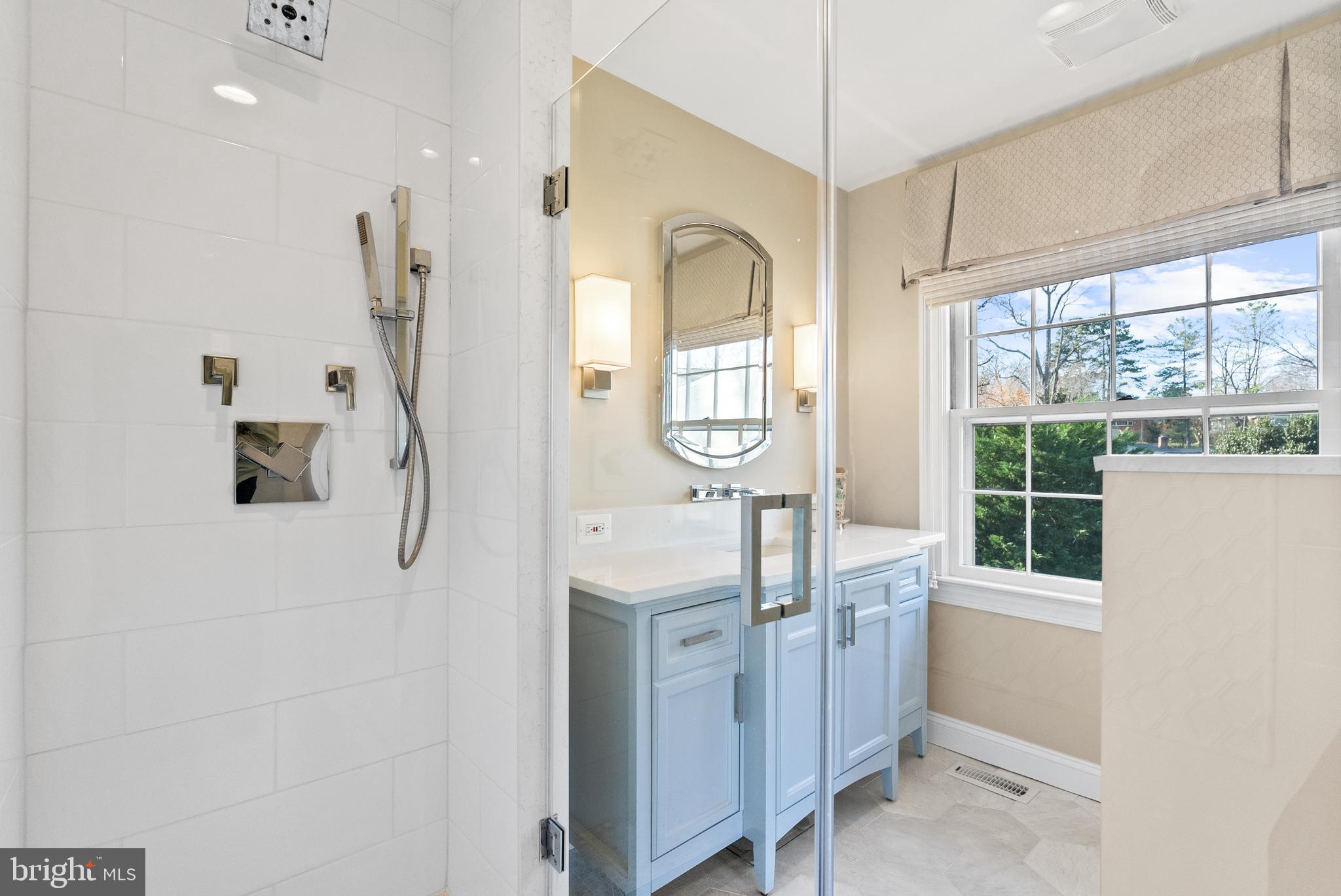 1101 Gatewood Drive Alexandria, VA 22307 - Photo 41 of 63 a bathroom with a double vanity sink a mirror and a shower