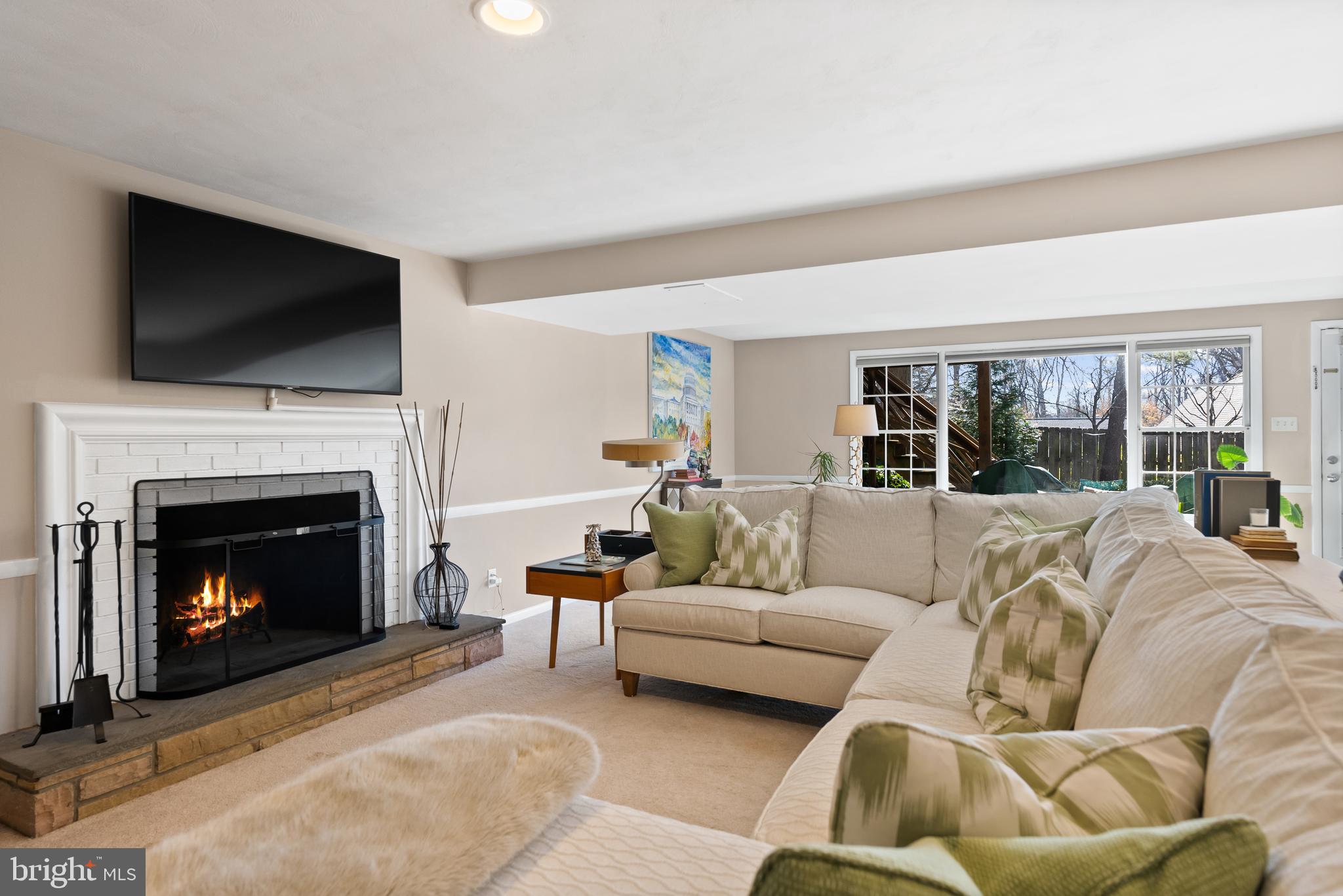 1101 Gatewood Drive Alexandria, VA 22307 - Photo 51 of 63 a living room with furniture a flat screen tv and a fireplace