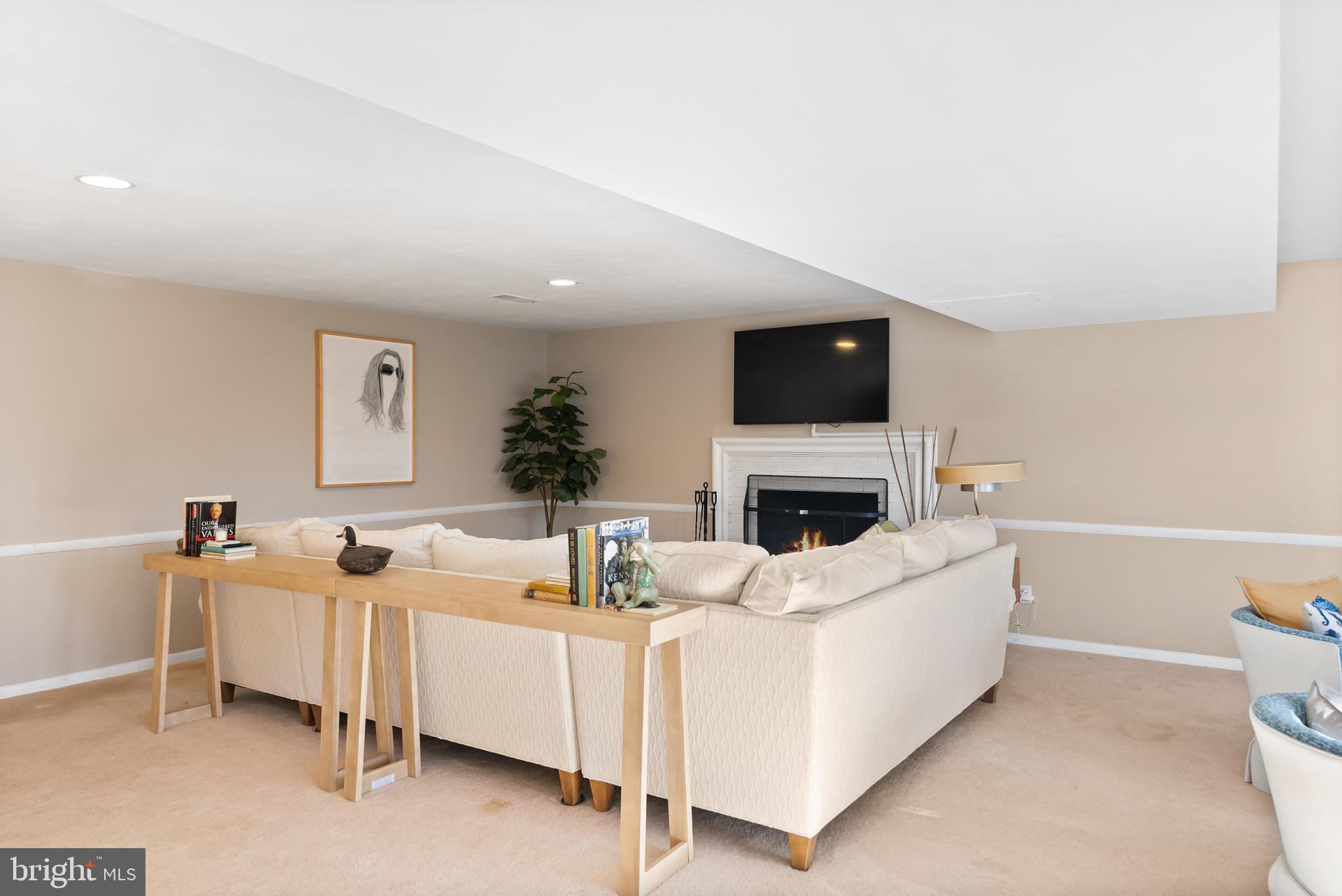 1101 Gatewood Drive Alexandria, VA 22307 - Photo 53 of 63 a living room with furniture a fireplace and a flat screen tv