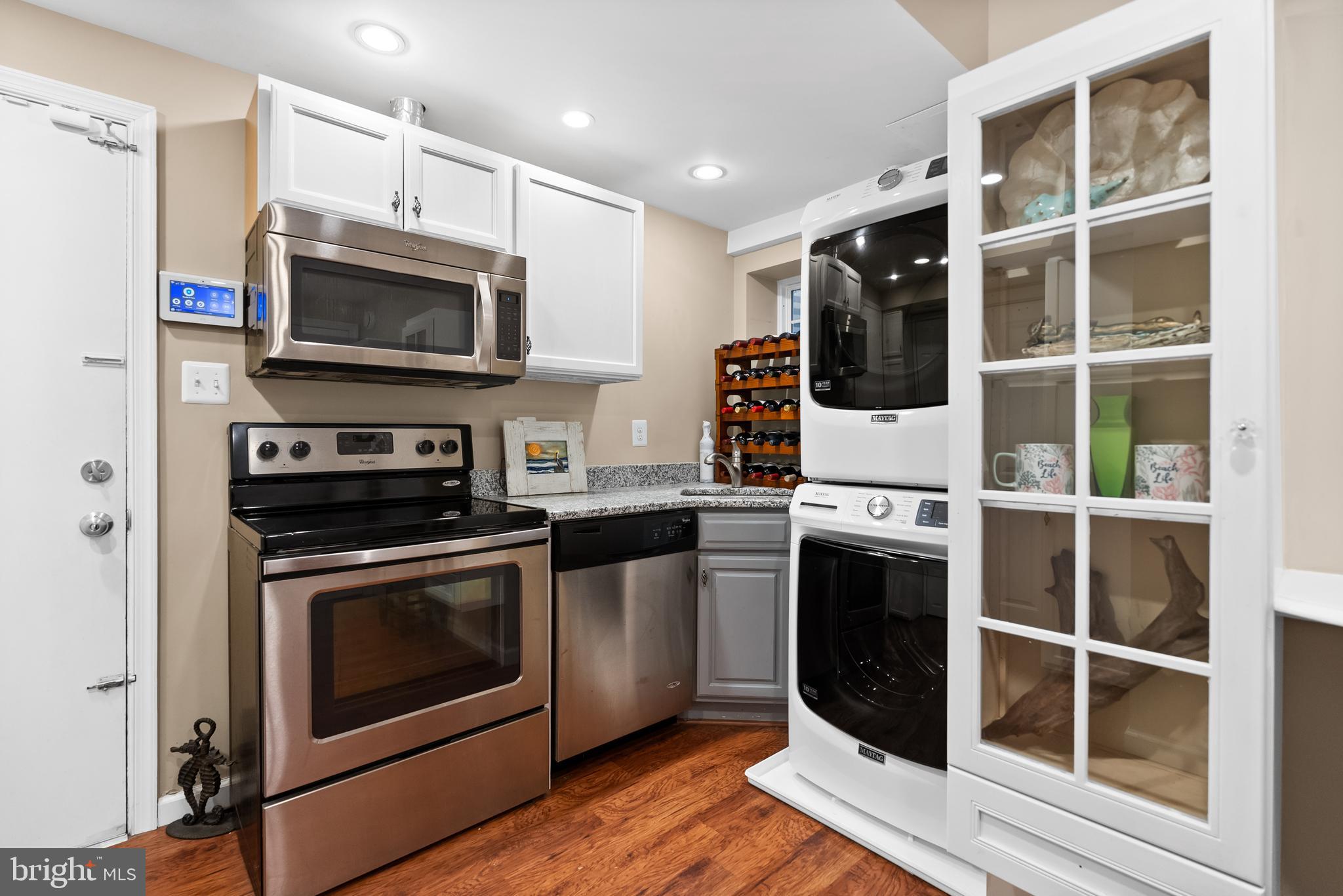 1101 Gatewood Drive Alexandria, VA 22307 - Photo 59 of 63 a kitchen with stainless steel appliances a stove a microwave and cabinets