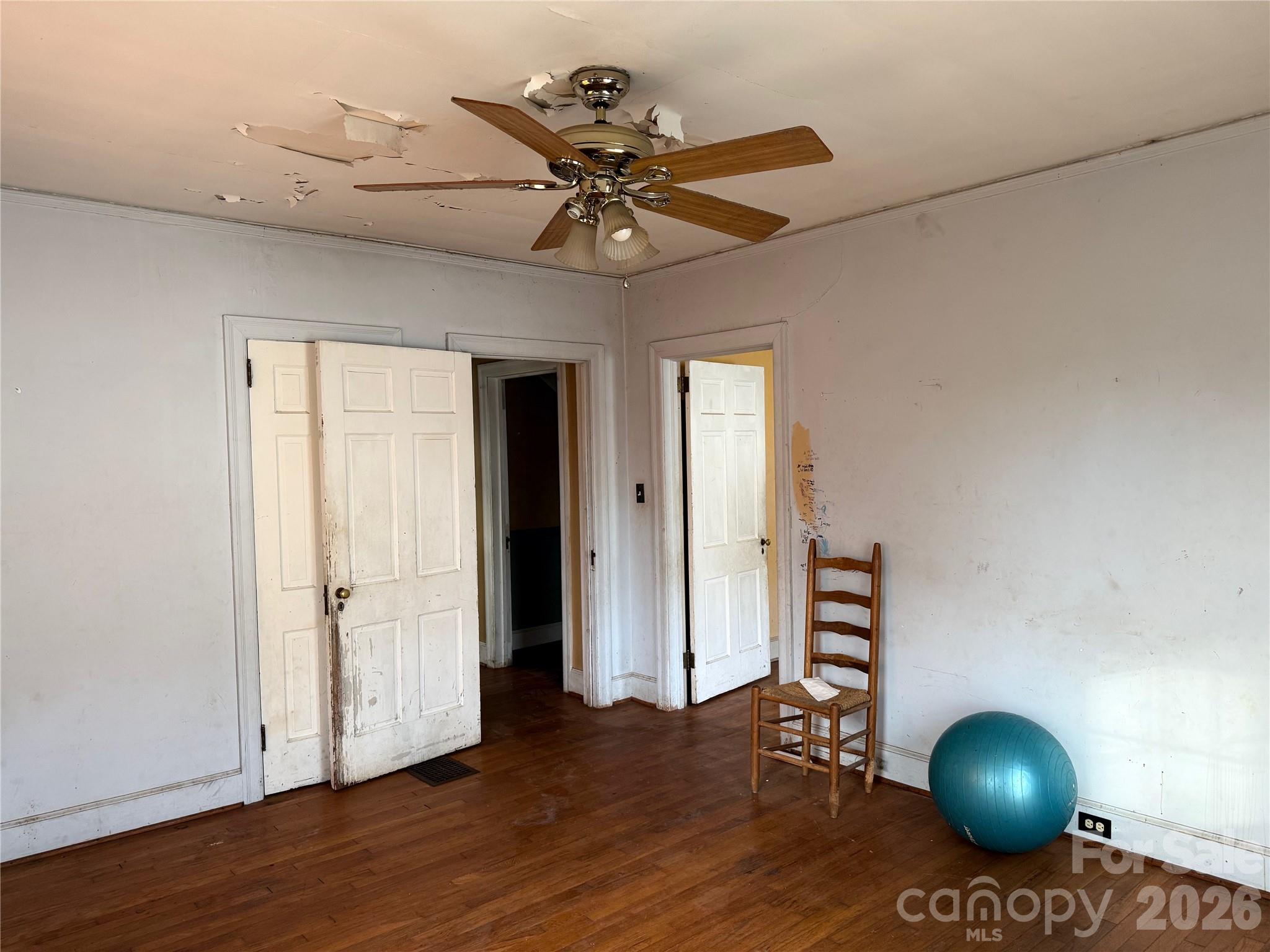 104 Brookhill Road Shelby, NC 28150 - Photo 13 of 40 a view of a livingroom with wooden floor and a ceiling fan