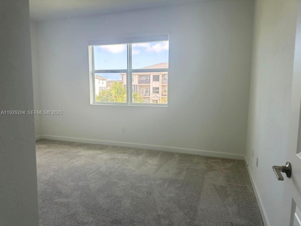 393 Southeast Crossoak Lane Port St. Lucie, FL 34984 - Photo 5 of 10 an empty room with a window