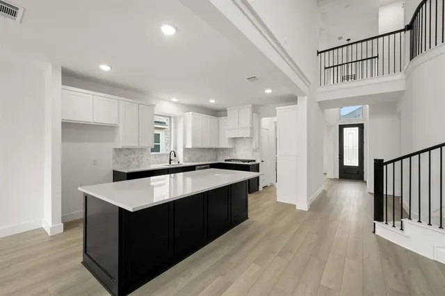 a kitchen with kitchen island sink and center island