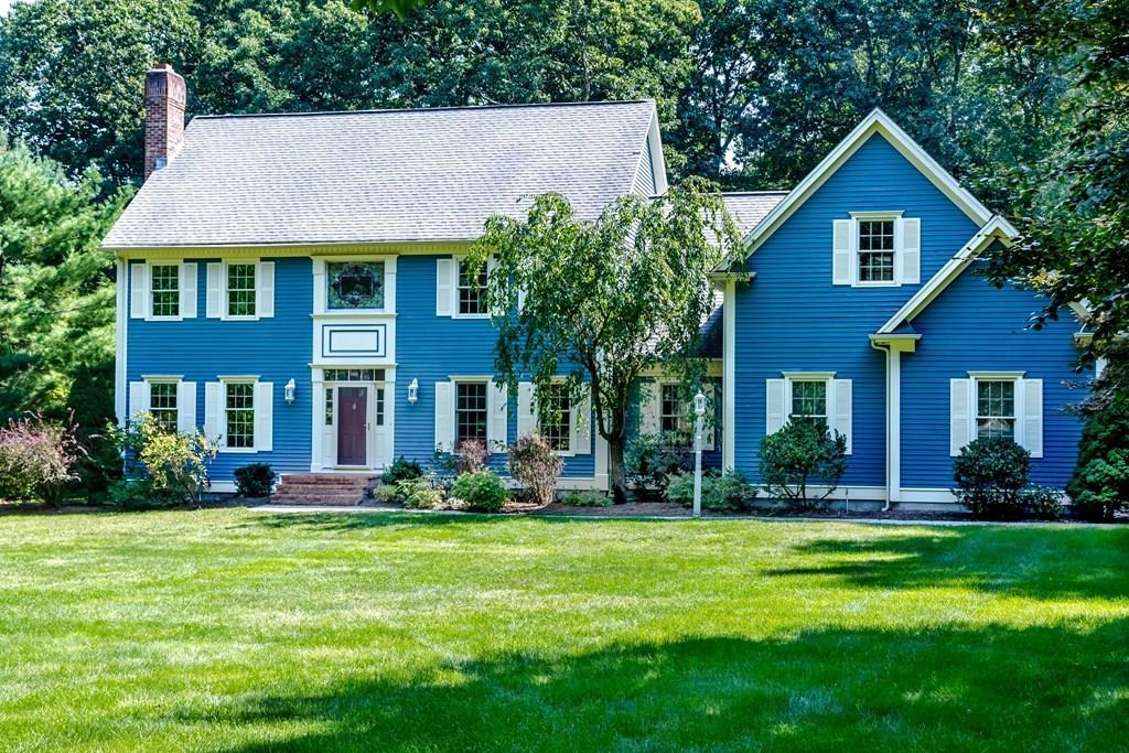 38 Bowditch Road Sudbury, MA 01776 - Photo 1 of 42 a front view of a house with a yard and trees