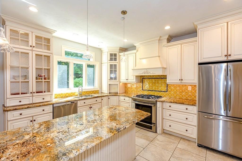 38 Bowditch Road Sudbury, MA 01776 - Photo 11 of 42 a large kitchen with granite countertop a stove a sink and a refrigerator