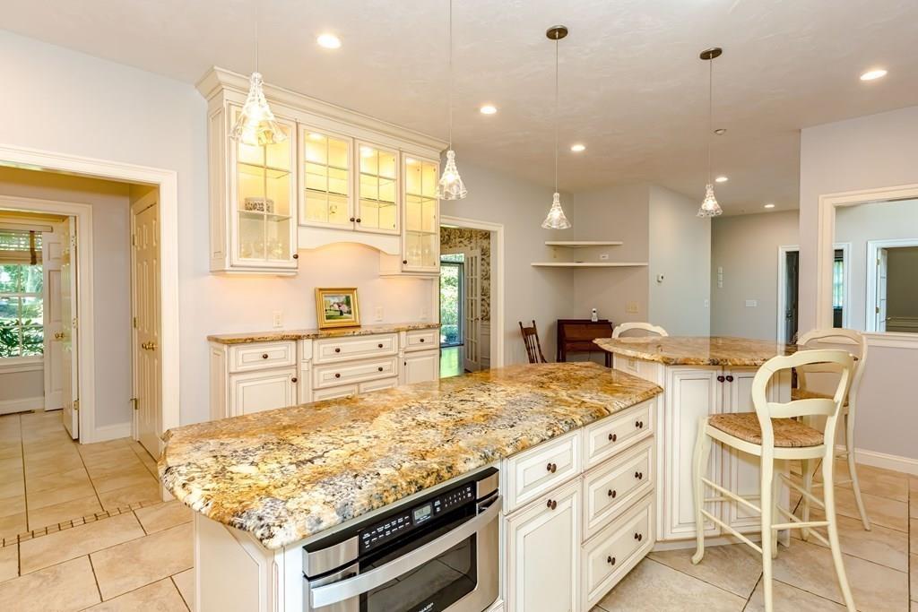 38 Bowditch Road Sudbury, MA 01776 - Photo 12 of 42 a kitchen with stainless steel appliances granite countertop a stove a sink and a refrigerator