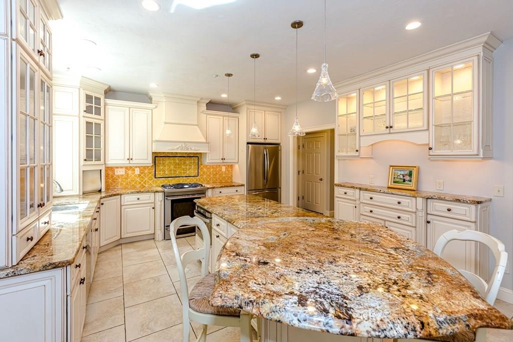 38 Bowditch Road Sudbury, MA 01776 - Photo 14 of 42 a open kitchen with granite countertop a stove refrigerator and cabinets