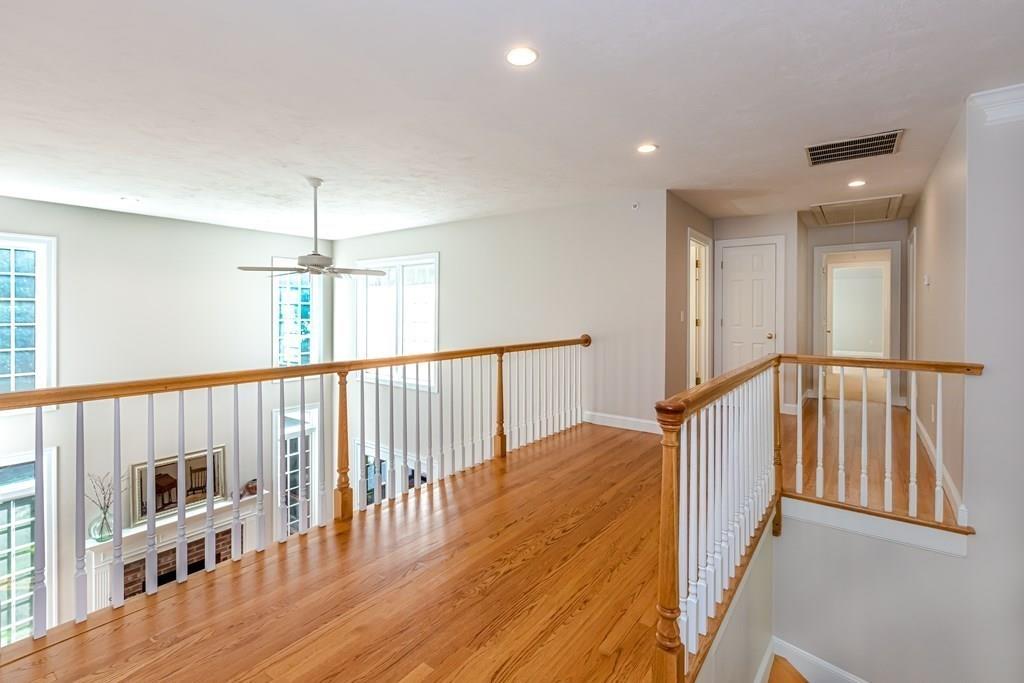 38 Bowditch Road Sudbury, MA 01776 - Photo 20 of 42 a view of a hallway with wooden floor and staircase