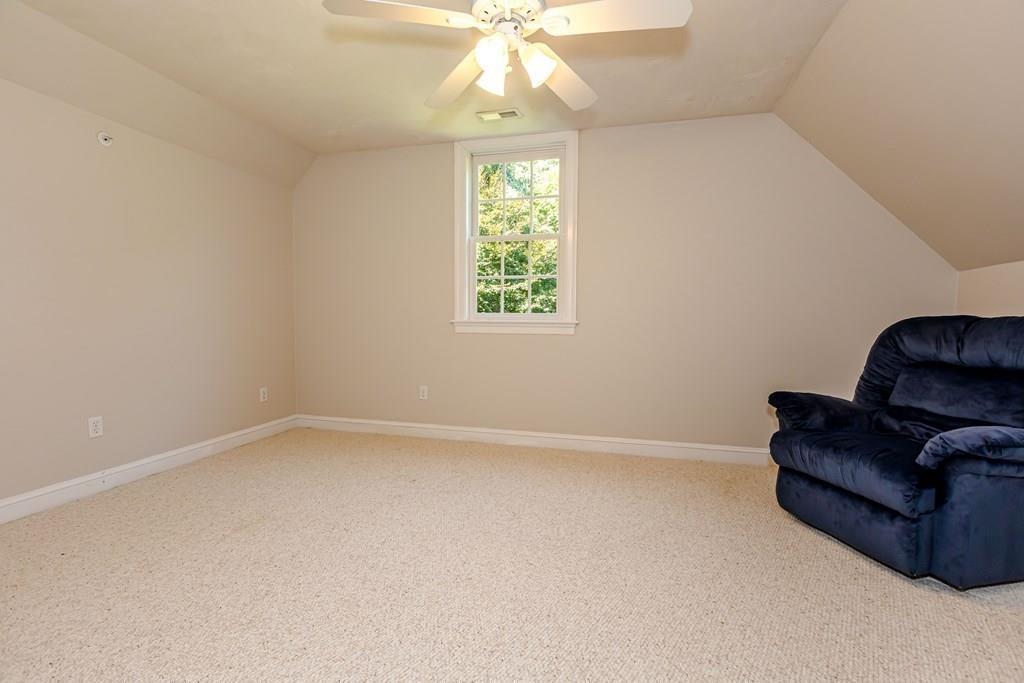 38 Bowditch Road Sudbury, MA 01776 - Photo 24 of 42 an empty room with windows and ceiling fan