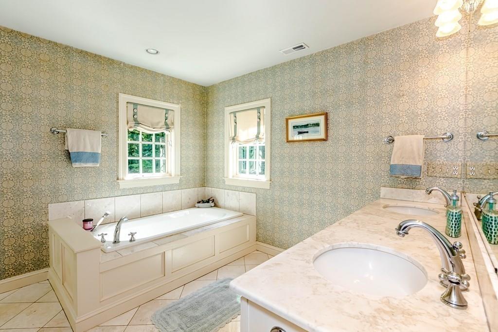 38 Bowditch Road Sudbury, MA 01776 - Photo 27 of 42 a bathroom with a tub sink and mirror
