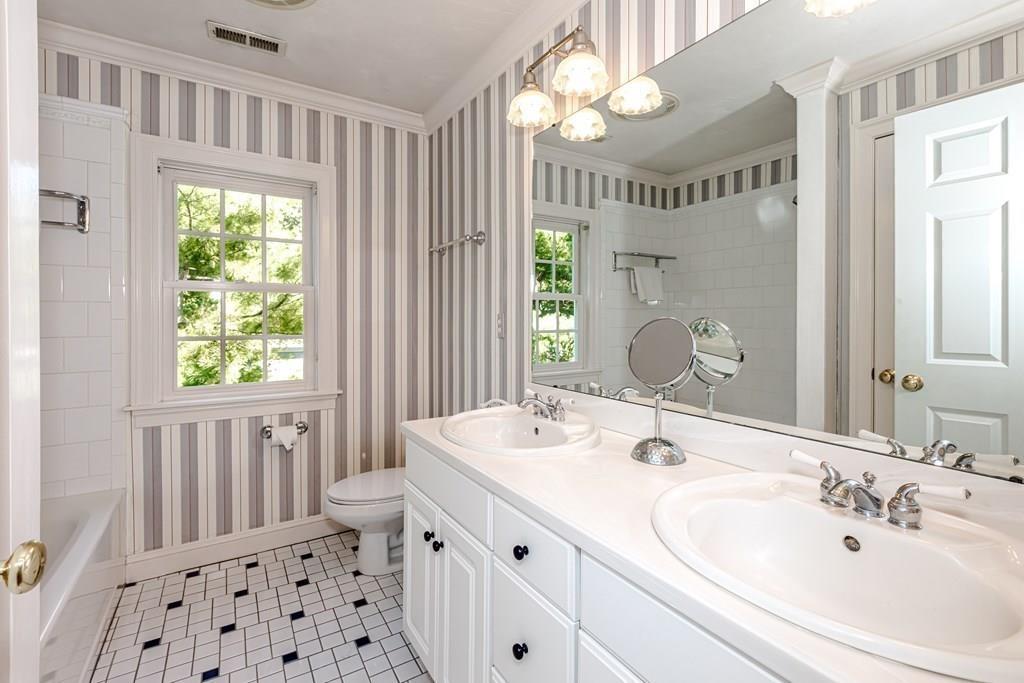 38 Bowditch Road Sudbury, MA 01776 - Photo 29 of 42 a bathroom with a double vanity sink mirror and a toilet