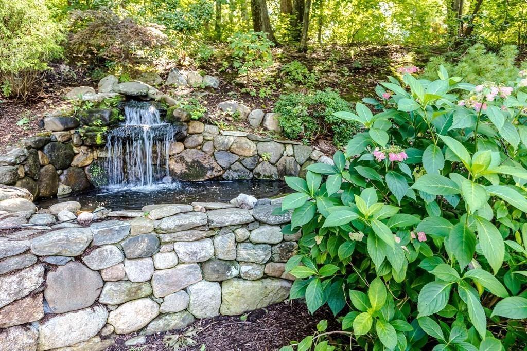 38 Bowditch Road Sudbury, MA 01776 - Photo 38 of 42 a view of a stone house with a tree
