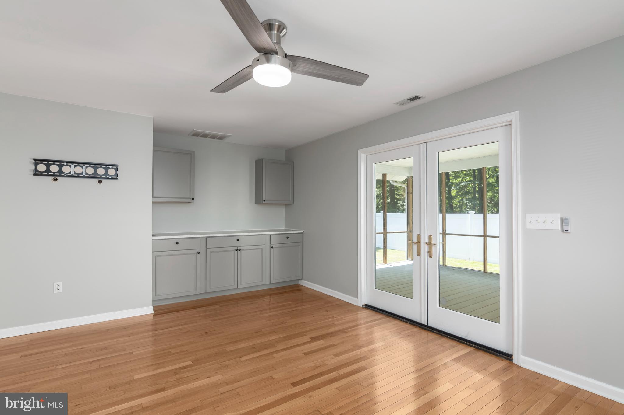 6824 Hopkins Neck Road Easton, MD 21601 - Photo 12 of 45 a view of an empty room with window and wooden floor