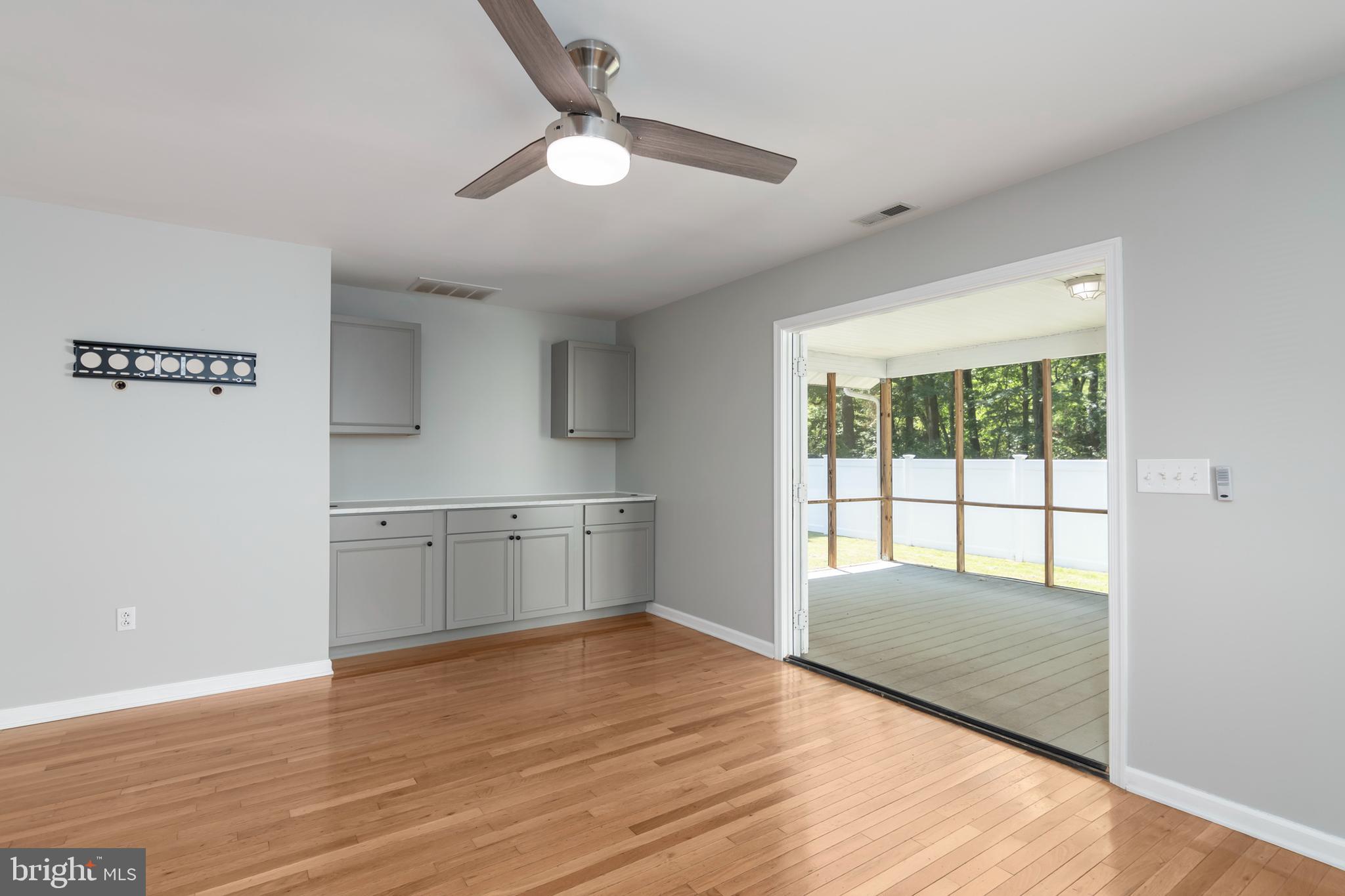 6824 Hopkins Neck Road Easton, MD 21601 - Photo 13 of 45 a view of an empty room with window and wooden floor
