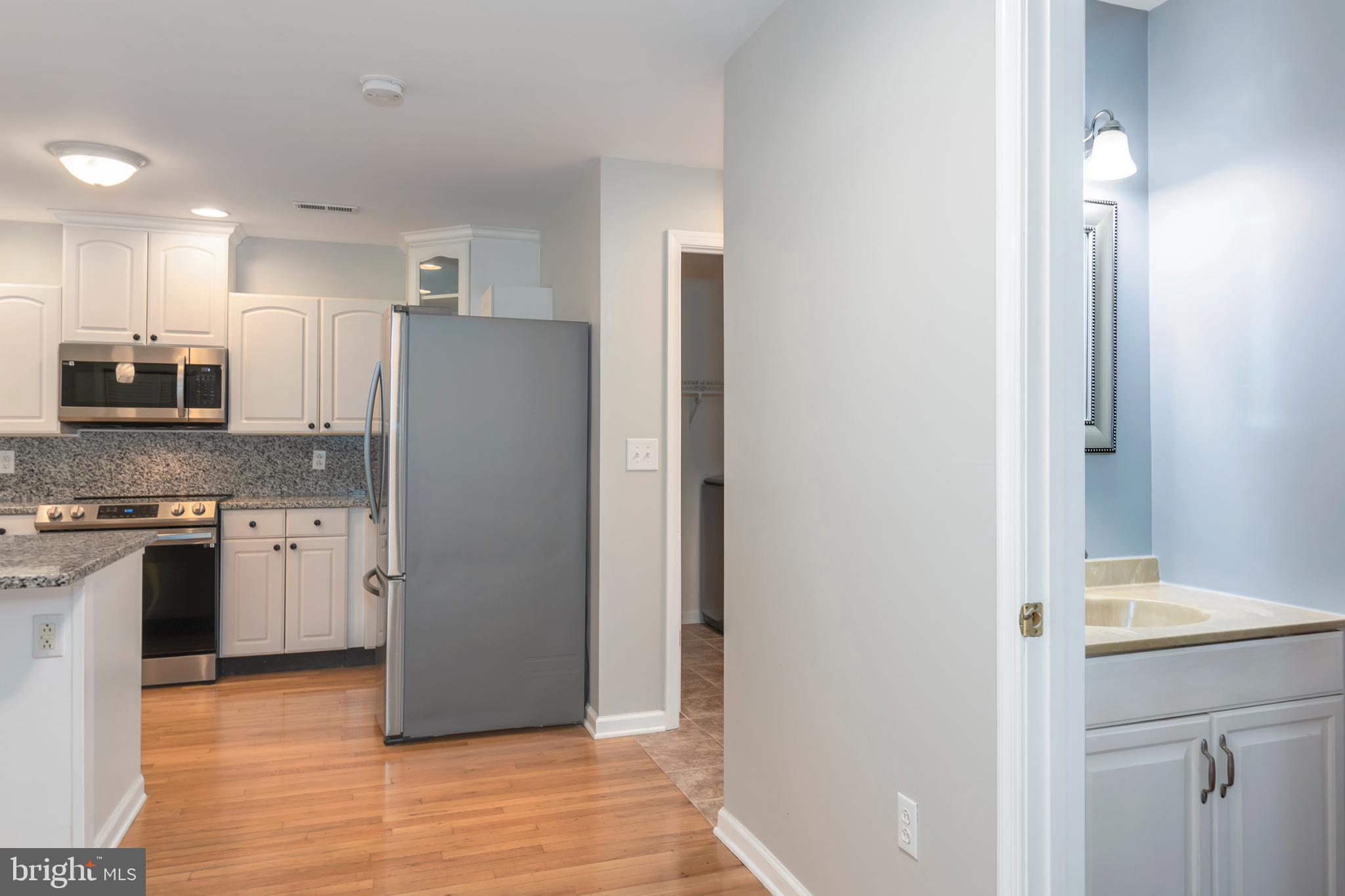 6824 Hopkins Neck Road Easton, MD 21601 - Photo 16 of 45 a kitchen with stainless steel appliances granite countertop a refrigerator and a stove top oven