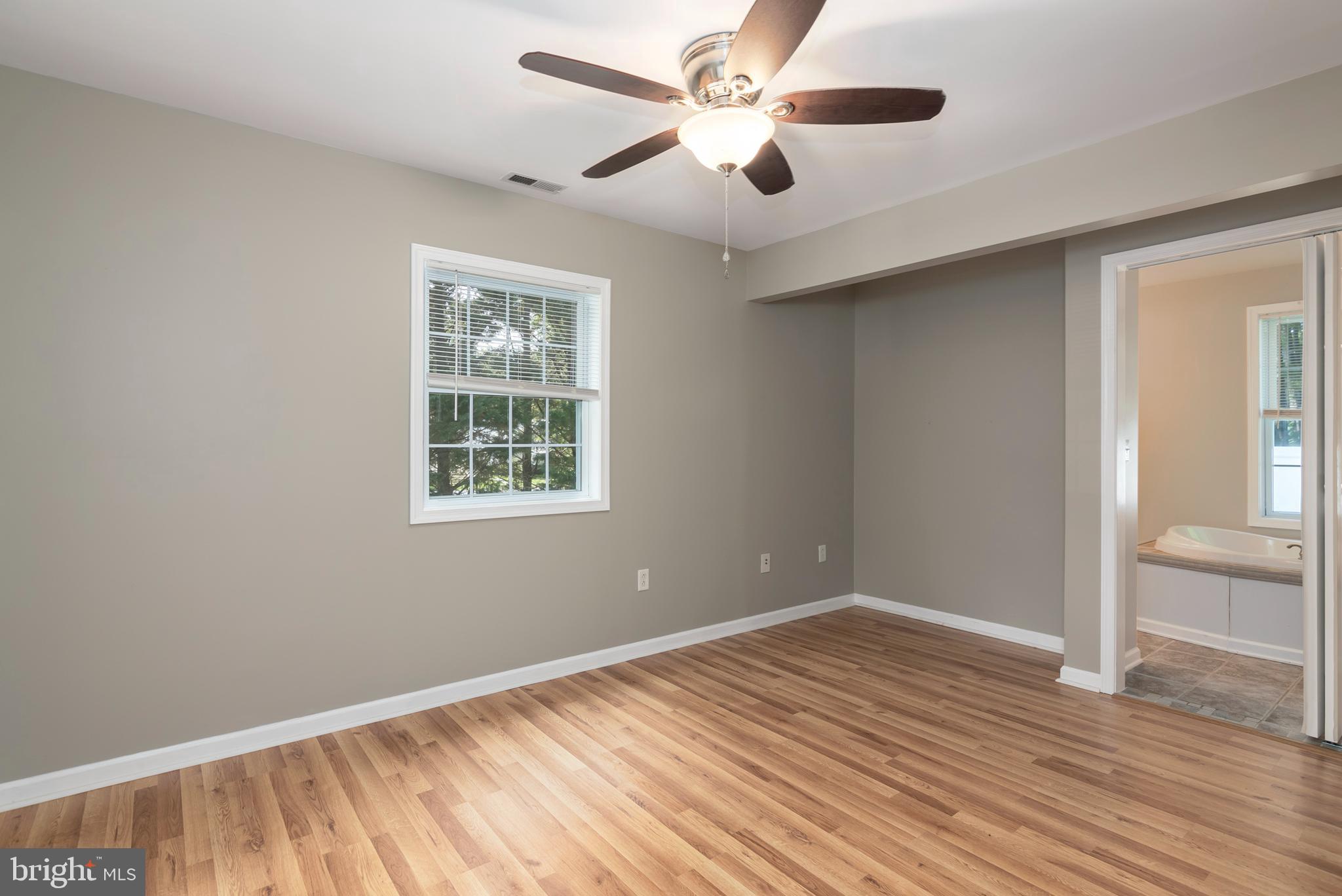 6824 Hopkins Neck Road Easton, MD 21601 - Photo 21 of 45 a view of an empty room with window and wooden floor