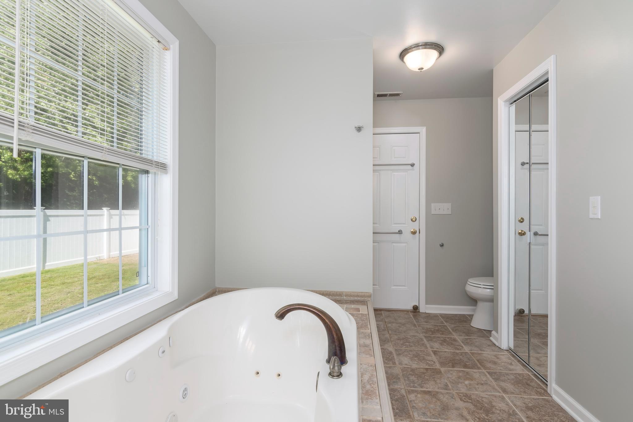 6824 Hopkins Neck Road Easton, MD 21601 - Photo 24 of 45 a view of a bathroom with a tub and shower