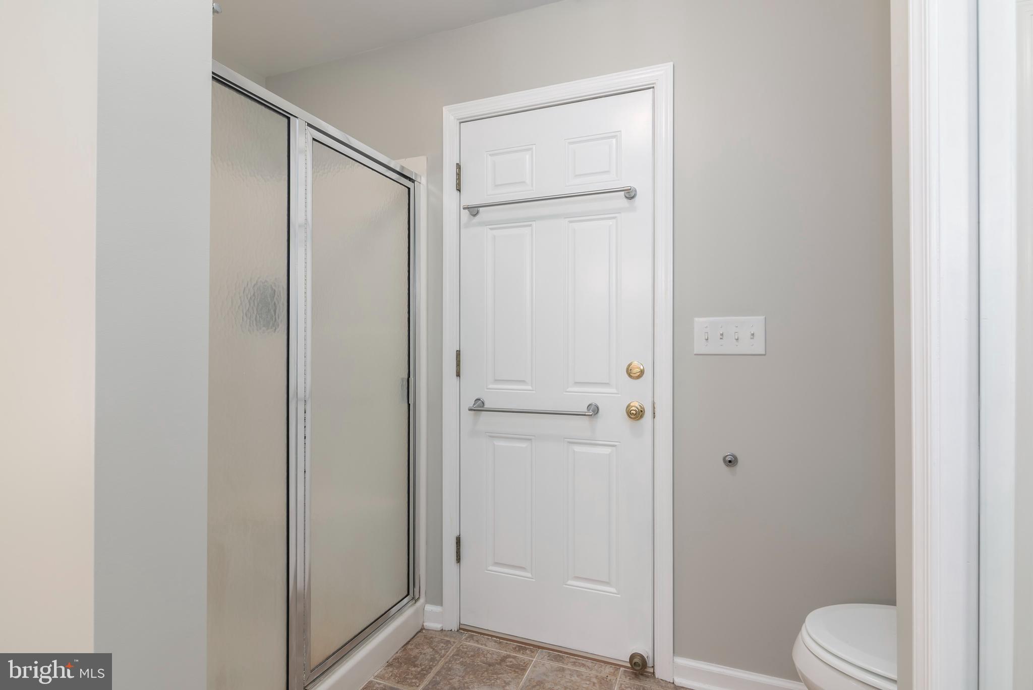6824 Hopkins Neck Road Easton, MD 21601 - Photo 25 of 45 a bathroom with a shower a toilet and a sink