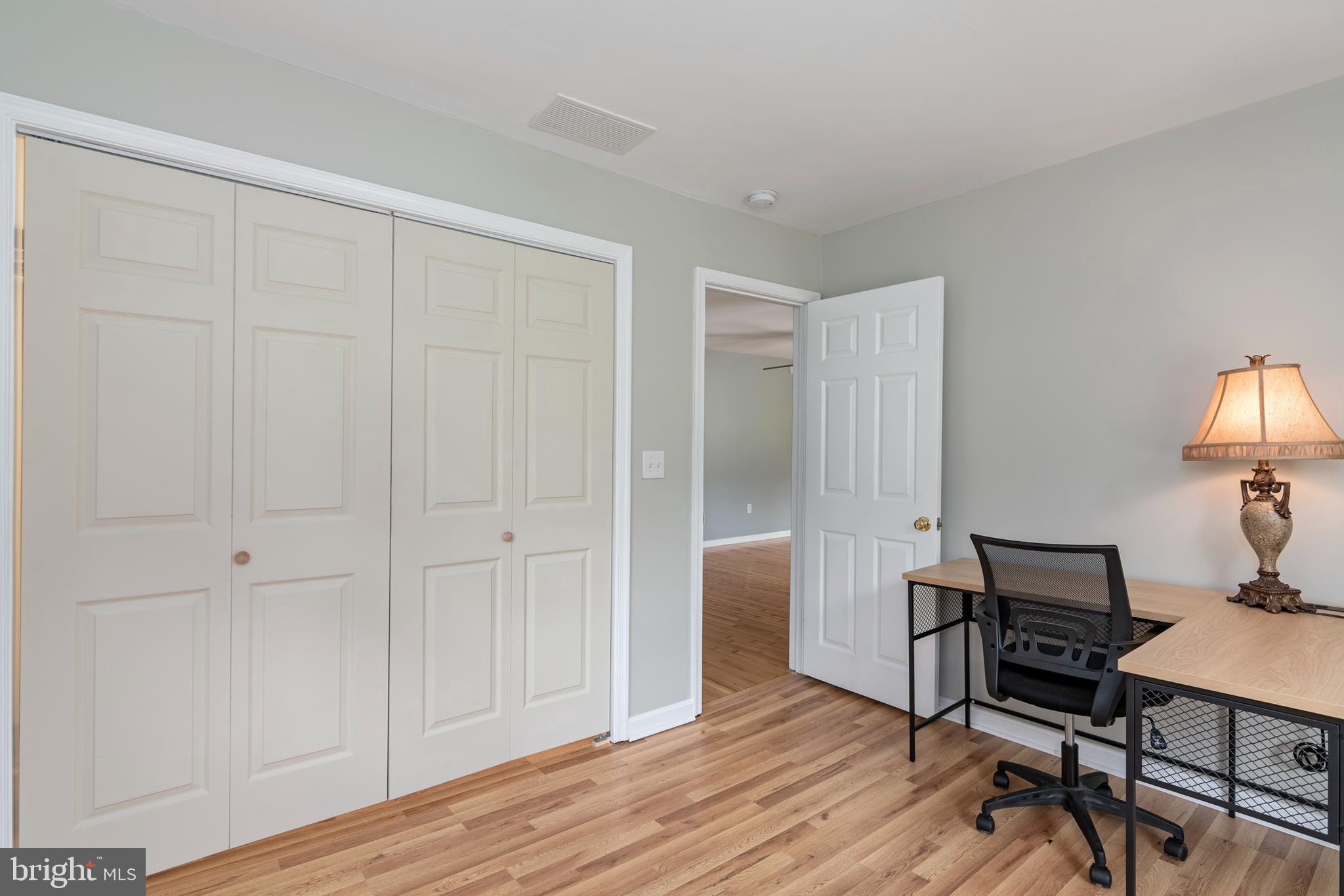 6824 Hopkins Neck Road Easton, MD 21601 - Photo 27 of 45 a view of a workspace with furniture and wooden floor