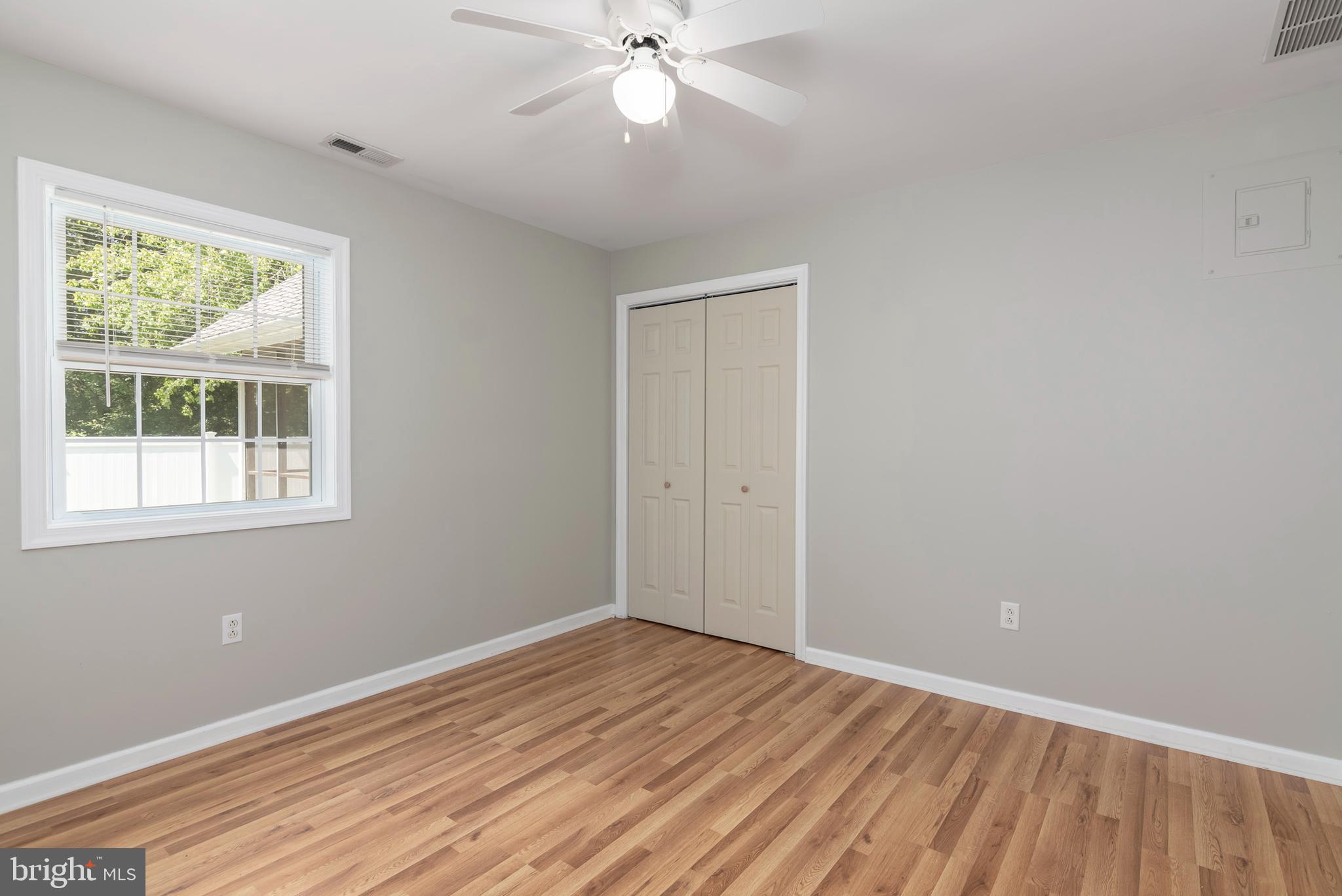 6824 Hopkins Neck Road Easton, MD 21601 - Photo 30 of 45 a view of an empty room with wooden floor and a window