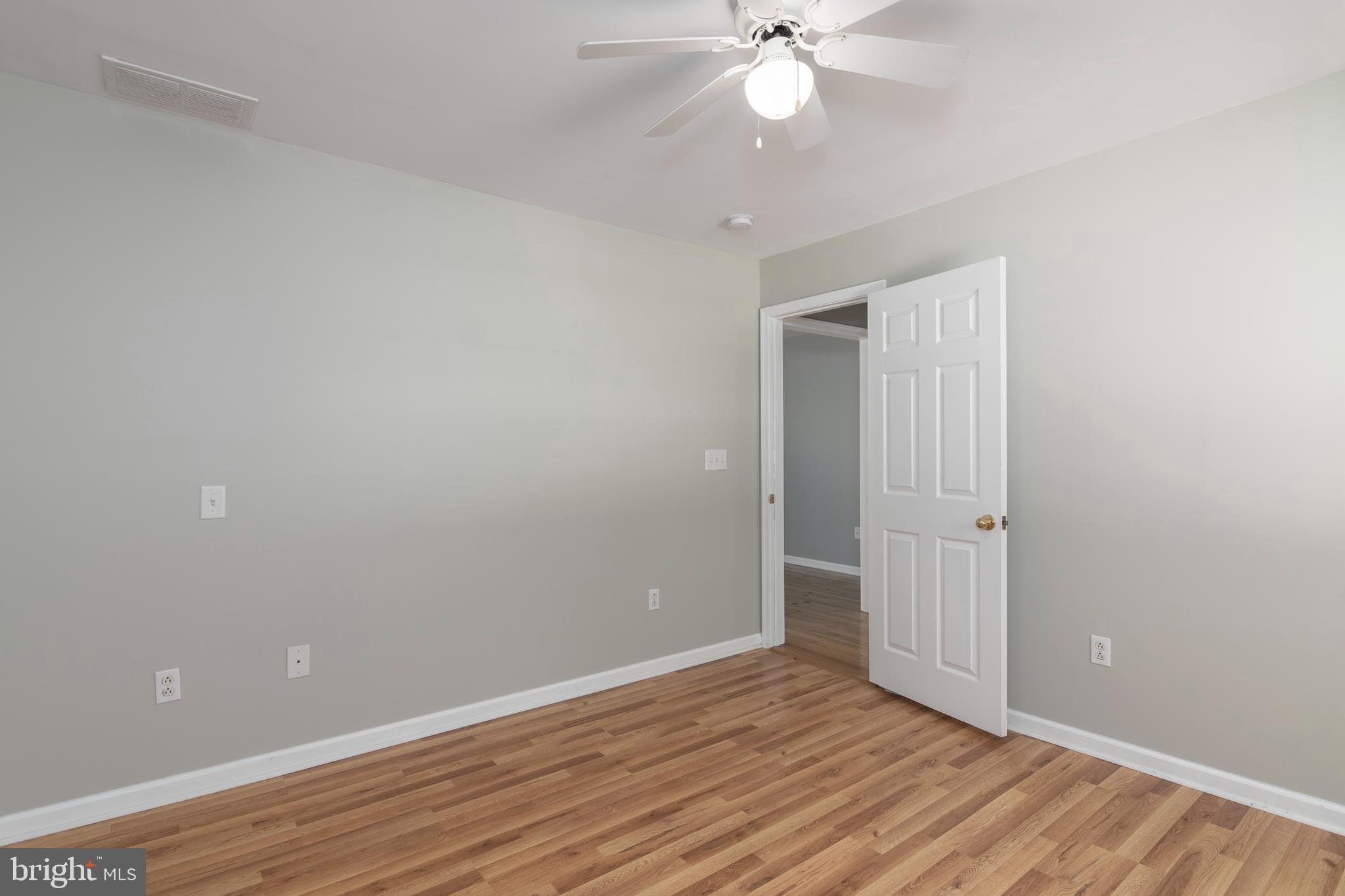 6824 Hopkins Neck Road Easton, MD 21601 - Photo 31 of 45 a view of an empty room with wooden floor