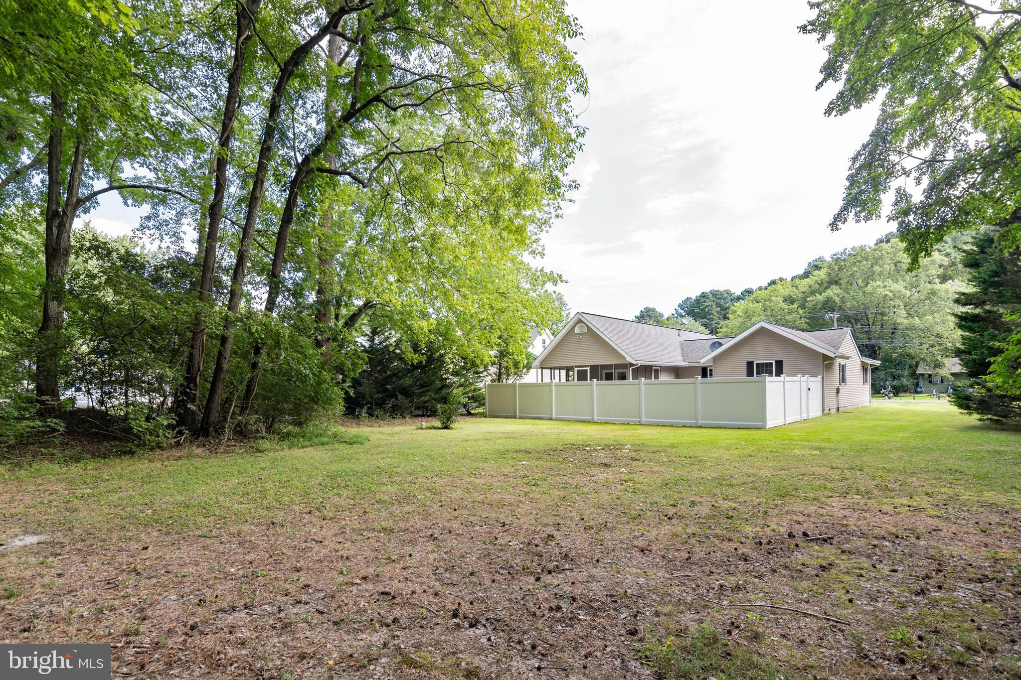 6824 Hopkins Neck Road Easton, MD 21601 - Photo 34 of 45 a view of of a house with a yard and large trees
