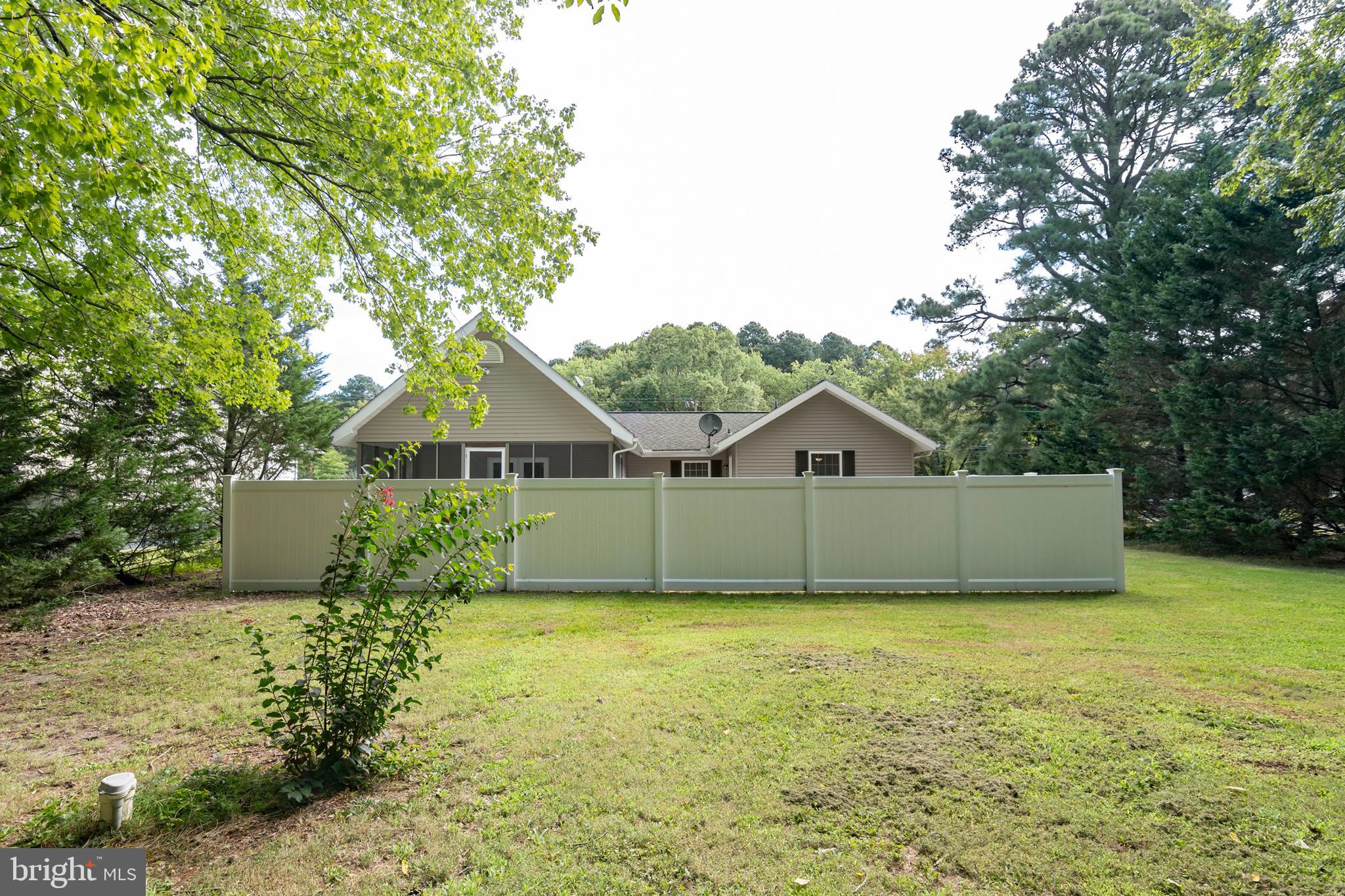 6824 Hopkins Neck Road Easton, MD 21601 - Photo 36 of 45 a front view of house with yard and trees in the background