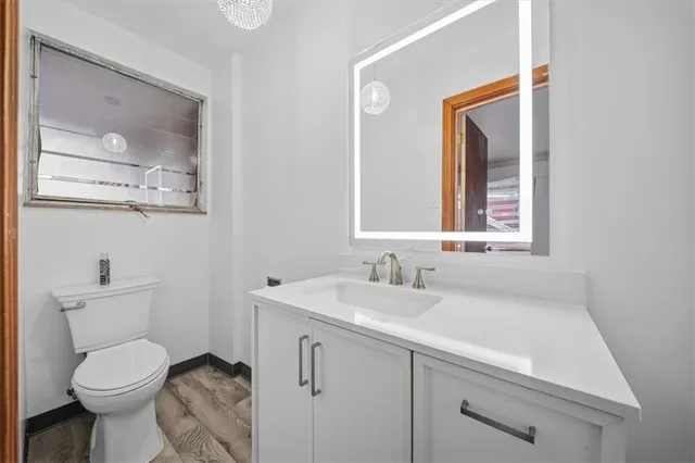 a bathroom with a toilet sink and mirror