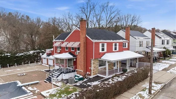 a front view of a house with sitting area