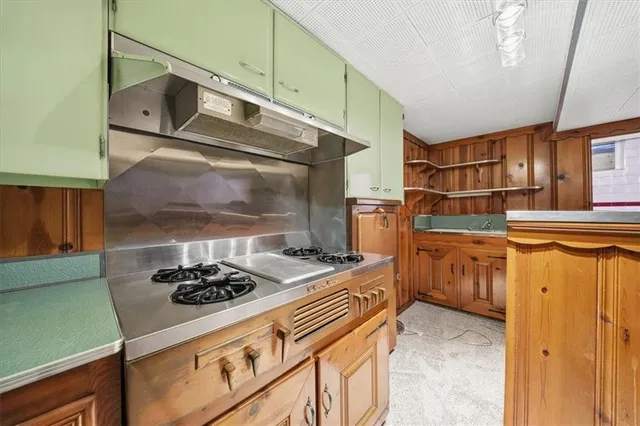 a kitchen with a stove and a cabinets