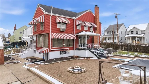 a front view of a building with sitting area