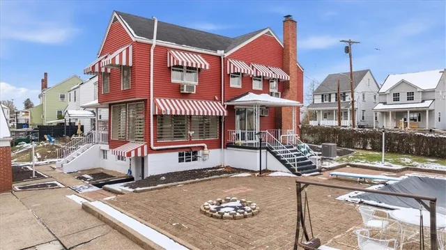 a front view of a building with sitting area
