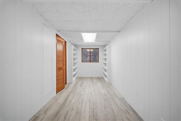 a view of a hallway with wooden floor