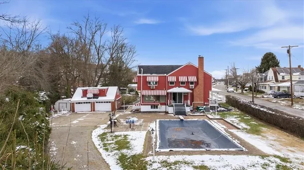 a house view with a sitting space fire pit and outdoor space