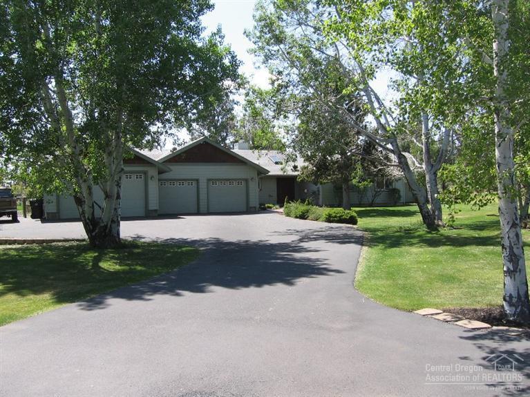 62433 Quail Ridge Road Bend, OR 97701 - Photo 1 of 25 a front view of a house with a yard and garage