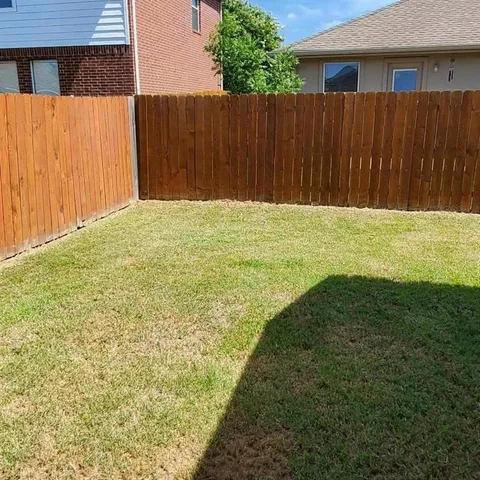 a view of outdoor space with wooden fence